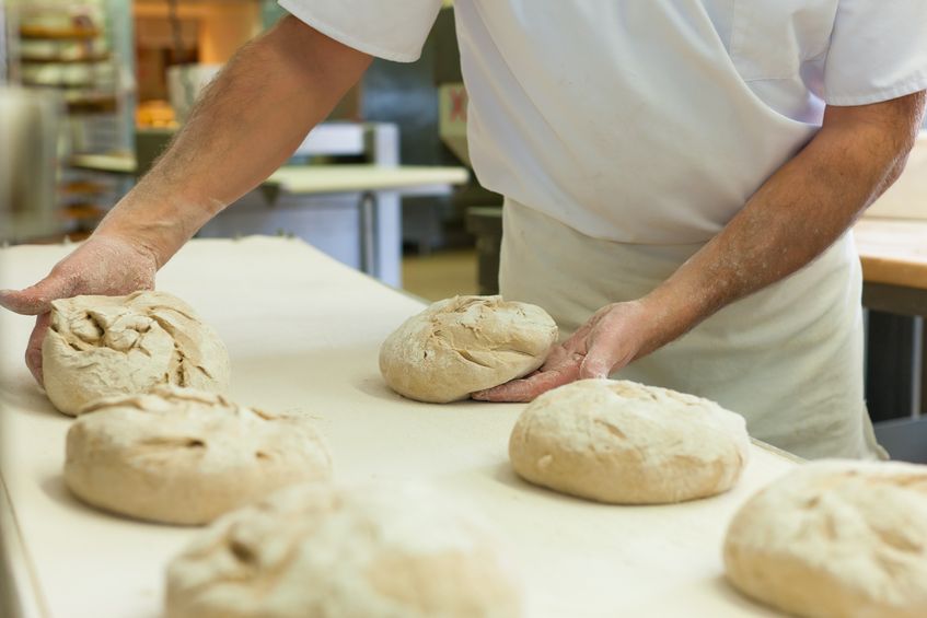 baker with fresh bread dough