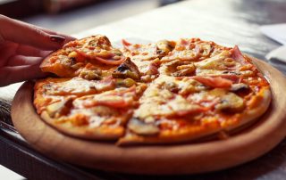 pizza with steam on wood deck