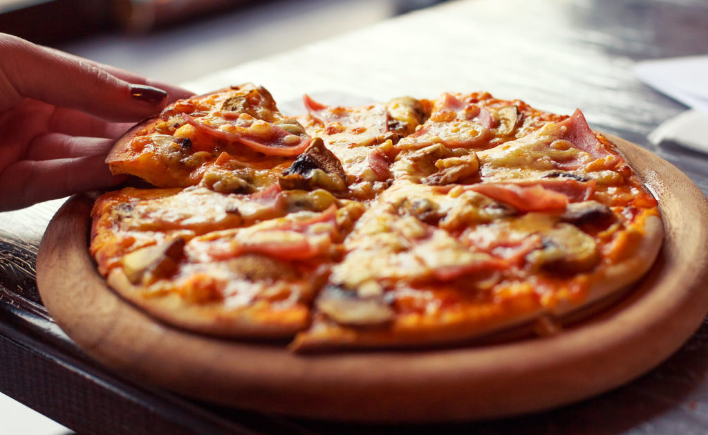 pizza with steam on wood deck